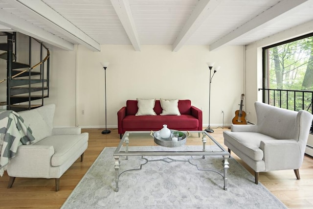 993 Massachusetts Ave Unit 127, Arlington, MA 02476 - living room featuring wood finished floors, stairway, baseboards, and beamed ceiling