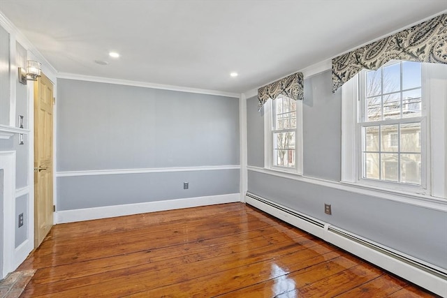 unfurnished dining area featuring hardwood / wood-style flooring, recessed lighting, crown molding, a baseboard radiator, and baseboards