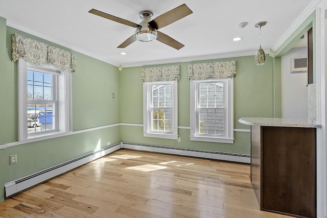 unfurnished dining area with light wood-style flooring, ornamental molding, recessed lighting, a baseboard radiator, and ceiling fan