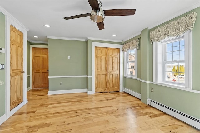 unfurnished bedroom featuring baseboard heating, recessed lighting, baseboards, and light wood-style floors