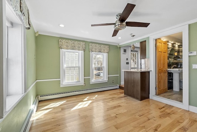 unfurnished room featuring light wood-type flooring, recessed lighting, crown molding, a baseboard radiator, and ceiling fan