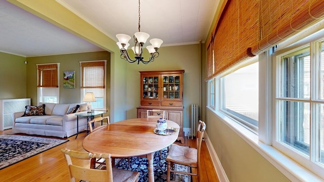 30 Hartshorn Ave, Worcester, MA 01602 - dining space featuring healthy amount of natural light, a chandelier, wood finished floors, and crown molding
