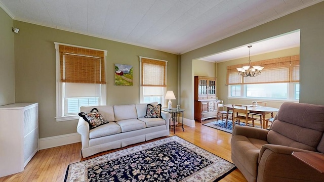 30 Hartshorn Ave, Worcester, MA 01602 - living room featuring ornamental molding, healthy amount of natural light, a chandelier, light wood finished floors, and baseboards