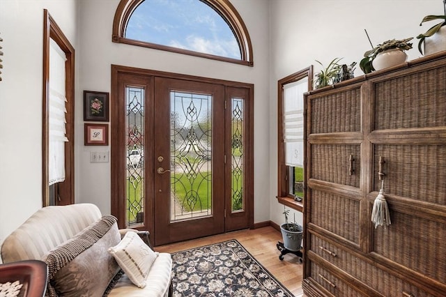 entryway featuring light wood-style floors and baseboards