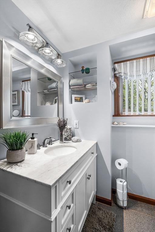 bathroom with baseboards and vanity