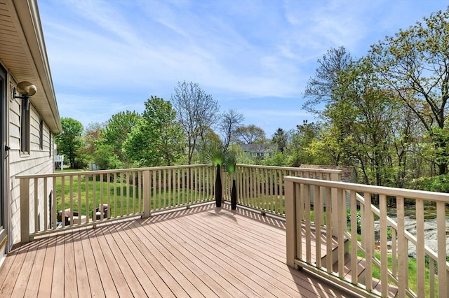 deck featuring view of wooded area