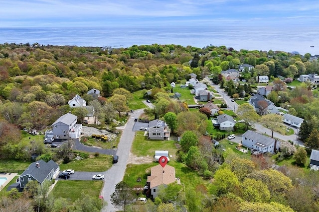 aerial view of property and surrounding area with a large body of water and nearby suburban area