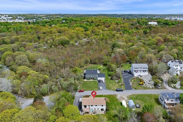 view of property location featuring a forest