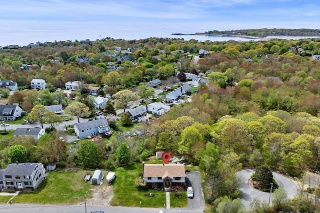 aerial view of property's location with a nearby body of water and nearby suburban area