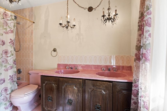 full bathroom featuring double vanity, toilet, shower / bath combination with curtain, and a sink