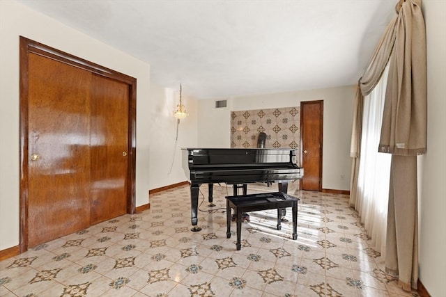 living area featuring baseboards and visible vents