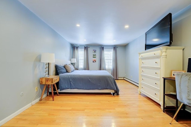 bedroom with light hardwood / wood-style flooring and a baseboard radiator