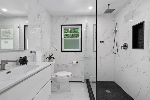 bathroom with tiled shower, toilet, tile walls, baseboard heating, and vanity