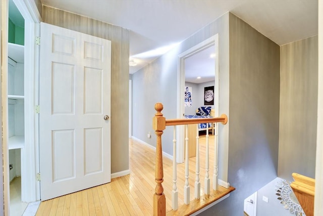 hallway with light hardwood / wood-style flooring