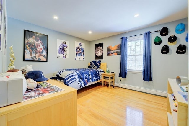 bedroom featuring a baseboard radiator and hardwood / wood-style floors