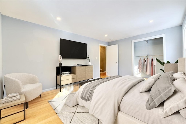 bedroom featuring light hardwood / wood-style floors and a closet