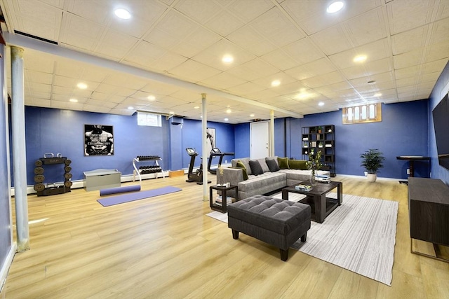 living room featuring a baseboard heating unit and light hardwood / wood-style floors