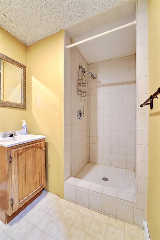 bathroom featuring vanity and tiled shower