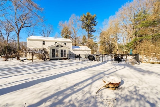 snow covered property featuring french doors