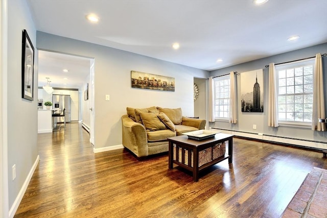 living room with hardwood / wood-style floors and baseboard heating