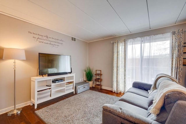 living room with dark wood-style flooring, visible vents, and baseboards