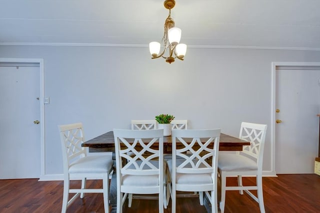 dining area featuring a chandelier, wood finished floors, and crown molding