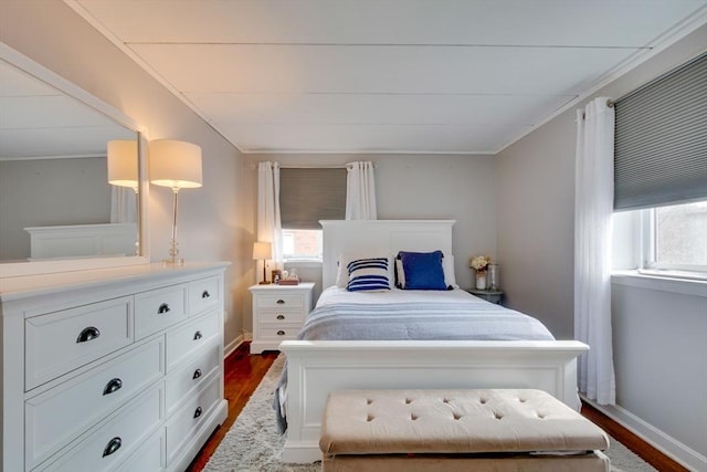 bedroom with baseboards, dark wood-style flooring, and ornamental molding