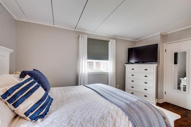 bedroom with ornamental molding and dark wood-style flooring