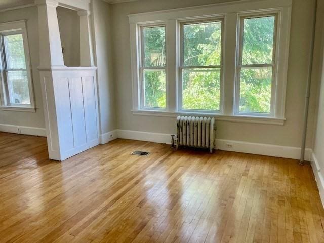 interior space featuring radiator and light hardwood / wood-style flooring