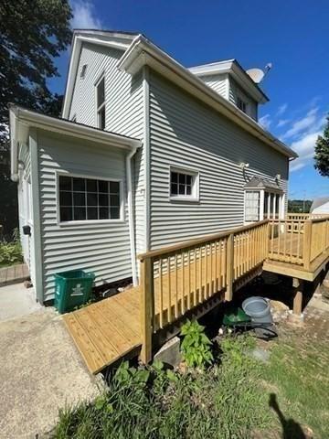 rear view of house with a wooden deck