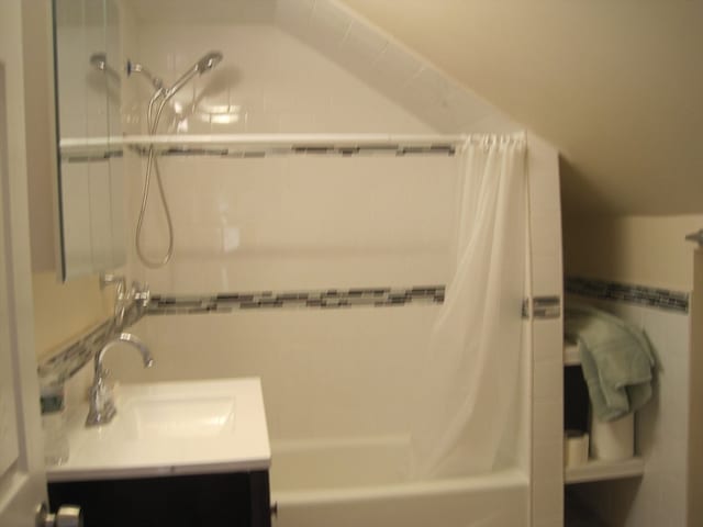 bathroom with vanity and shower / bath combination with curtain