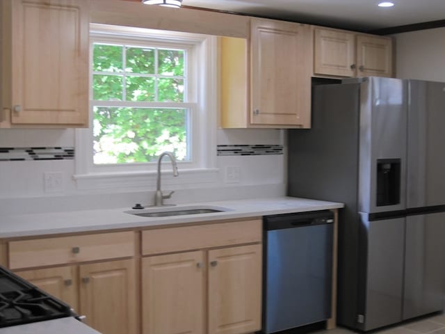 kitchen featuring a wealth of natural light, sink, stainless steel appliances, and light brown cabinets