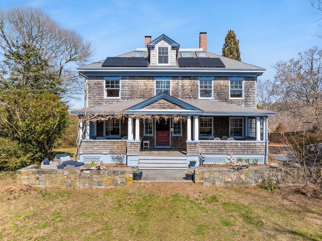 10 Quissett, Falmouth, MA 02543 - shingle-style home with a chimney, covered porch, a front lawn, and solar panels