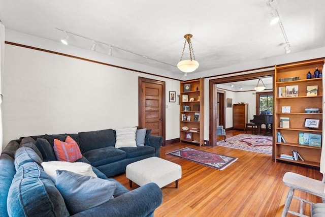 10 Quissett, Falmouth, MA 02543 - living area featuring track lighting, wood finished floors, and baseboards