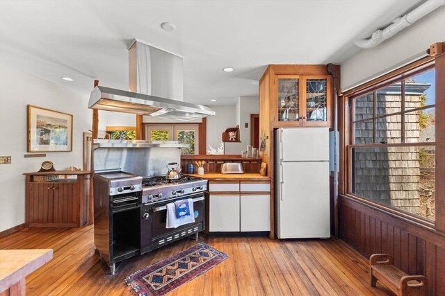 10 Quissett, Falmouth, MA 02543 - kitchen with freestanding refrigerator, island range hood, healthy amount of natural light, light wood finished floors, and recessed lighting