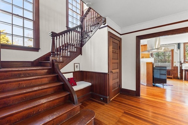10 Quissett, Falmouth, MA 02543 - stairs featuring hardwood / wood-style floors, crown molding, a wainscoted wall, and wood walls