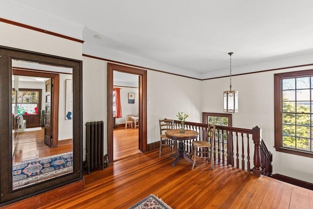 10 Quissett, Falmouth, MA 02543 - dining space with radiator, wood-type flooring, baseboards, and ornamental molding