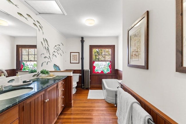 10 Quissett, Falmouth, MA 02543 - full bath with wainscoting, vanity, a freestanding tub, toilet, and healthy amount of natural light