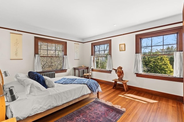 10 Quissett, Falmouth, MA 02543 - bedroom with baseboards, radiator heating unit, and wood finished floors