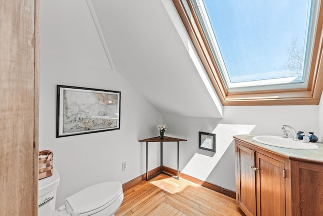 10 Quissett, Falmouth, MA 02543 - half bath with toilet, vanity, wood finished floors, a skylight, and lofted ceiling