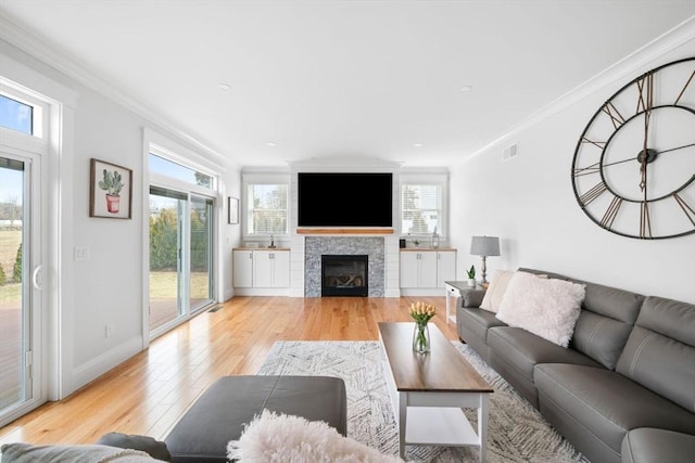 living room featuring crown molding and light wood-type flooring