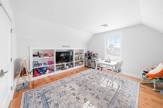 game room with lofted ceiling and hardwood / wood-style floors