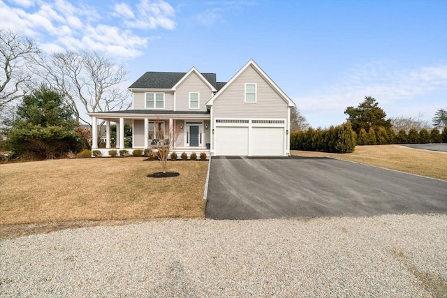 view of front facade featuring a garage, a front yard, and covered porch