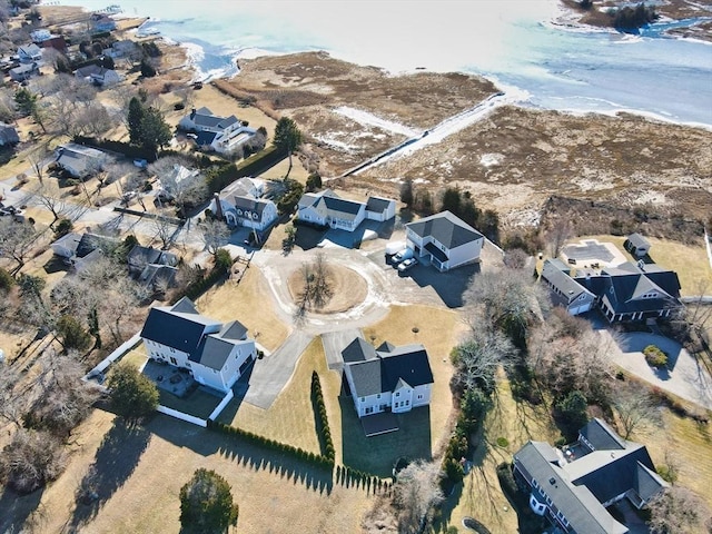 birds eye view of property featuring a water view and a beach view