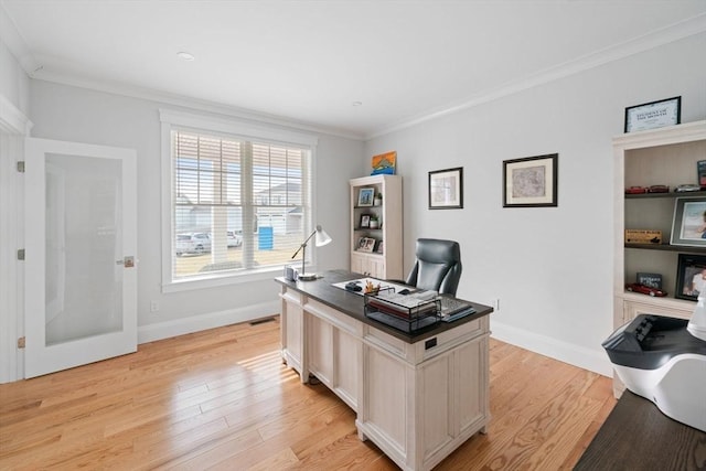 office area with crown molding and light hardwood / wood-style floors