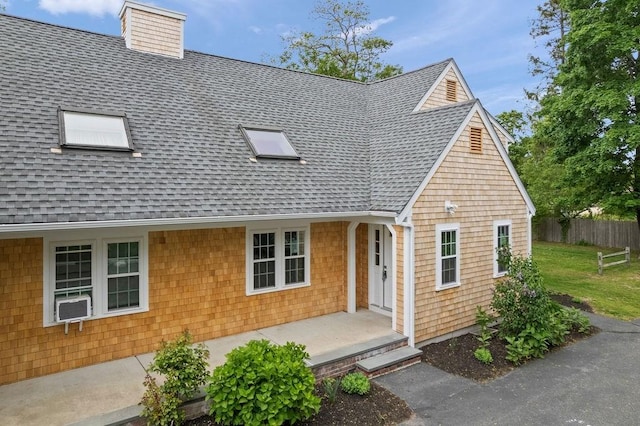 176 Palmer Ave Unit 2, Falmouth, MA 02540 - view of front facade featuring roof with shingles and a chimney