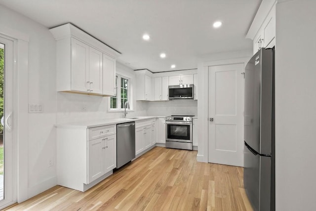 176 Palmer Ave Unit 2, Falmouth, MA 02540 - kitchen featuring appliances with stainless steel finishes, light wood finished floors, recessed lighting, white cabinetry, and light countertops