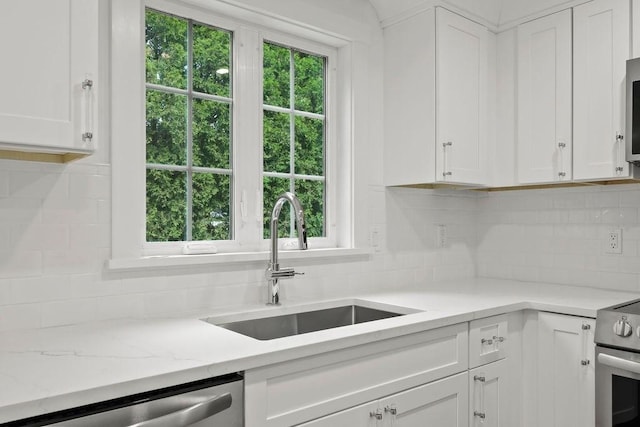 176 Palmer Ave Unit 2, Falmouth, MA 02540 - kitchen with appliances with stainless steel finishes, a sink, decorative backsplash, and white cabinetry