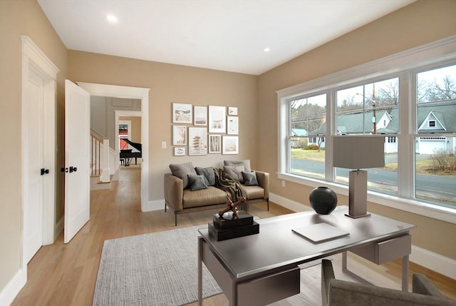 interior space with recessed lighting, baseboards, light wood-style flooring, and plenty of natural light