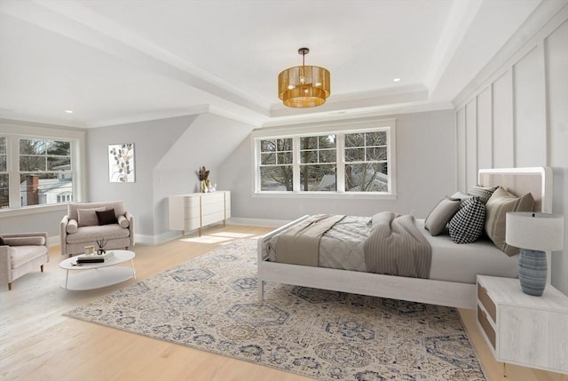 bedroom featuring recessed lighting, baseboards, wood finished floors, and a tray ceiling